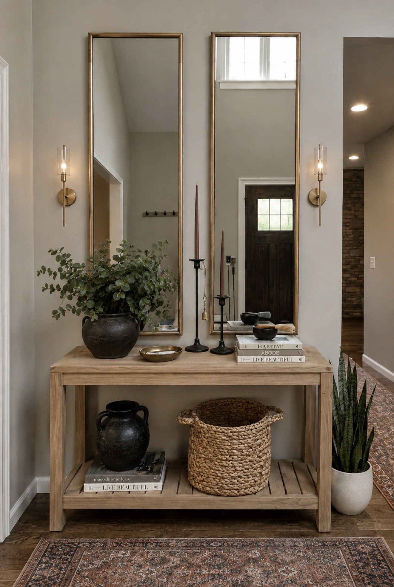 Entry console with brass sconces and twin mirrors