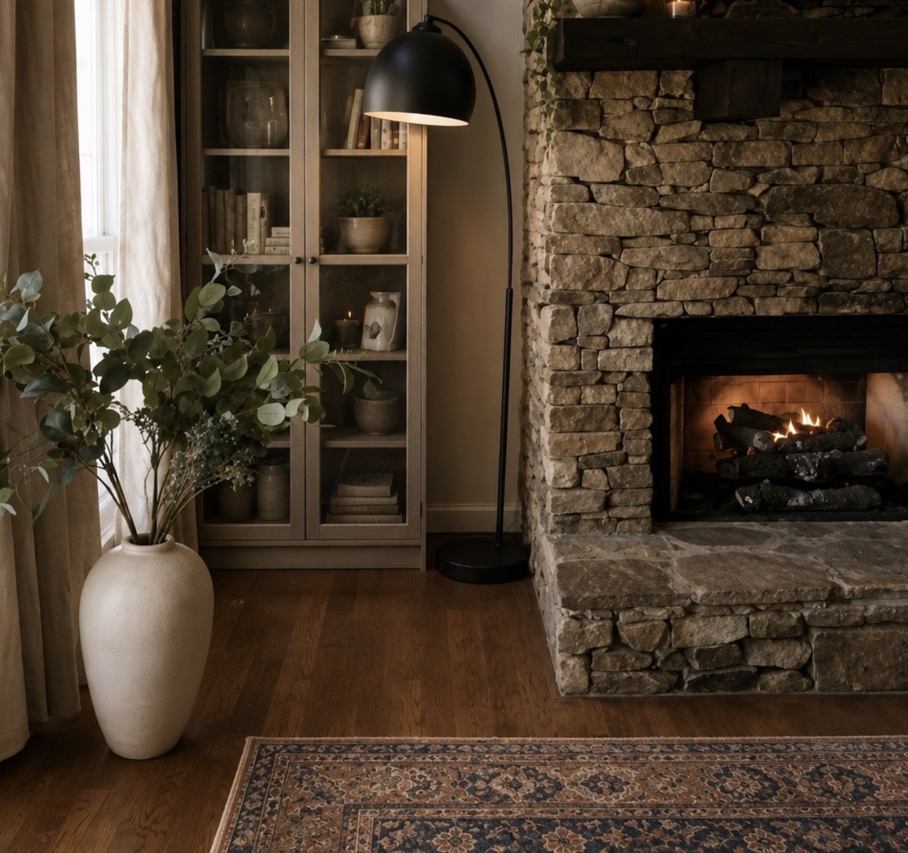 Dry-stacked stone hearth with arc floor lamp